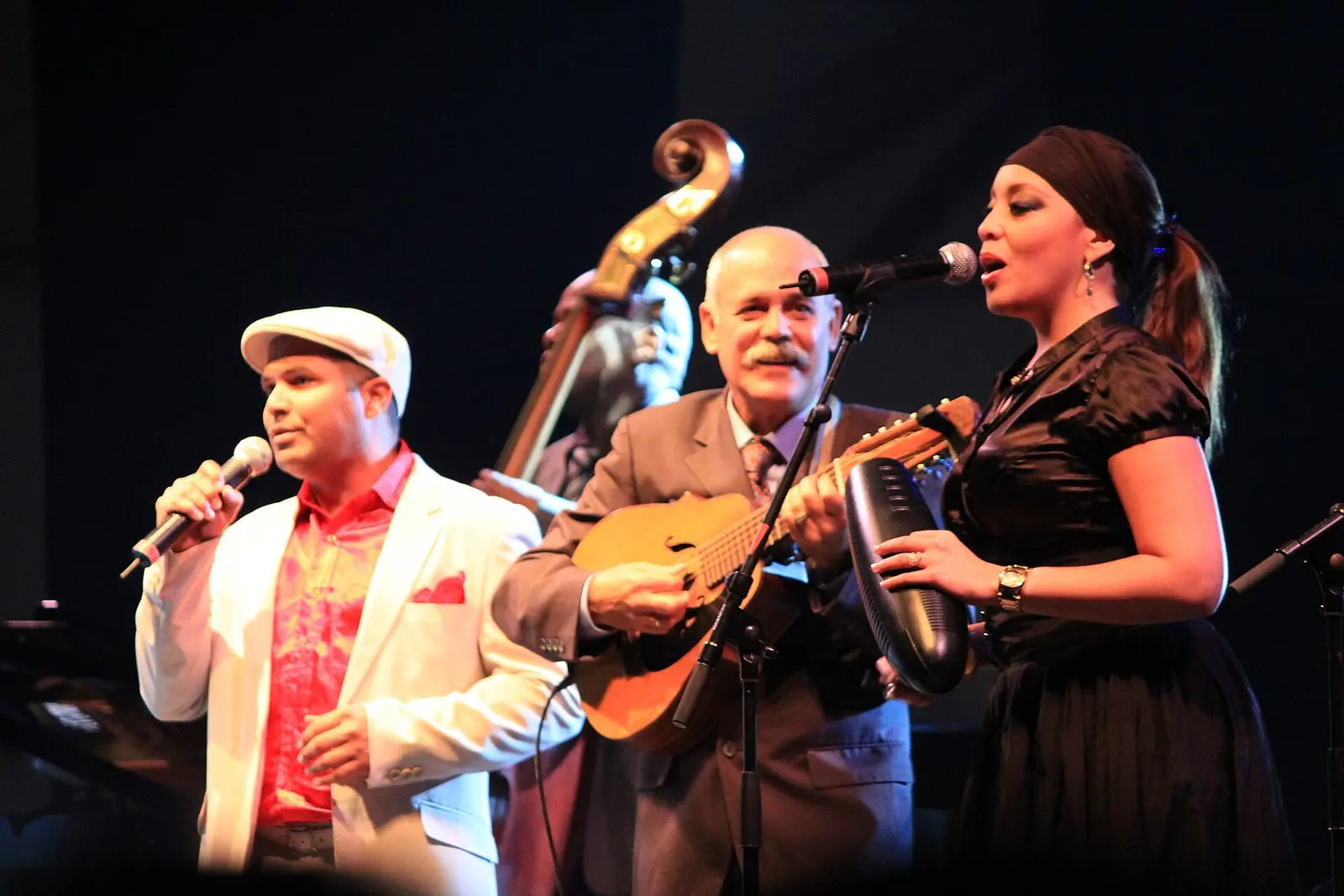 Singers of Orquesta Buena Vista Social Club in white jackets on stage