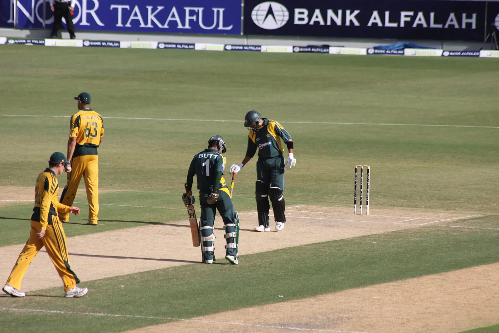 Batters walking out at a cricket match at Dubai Sports City