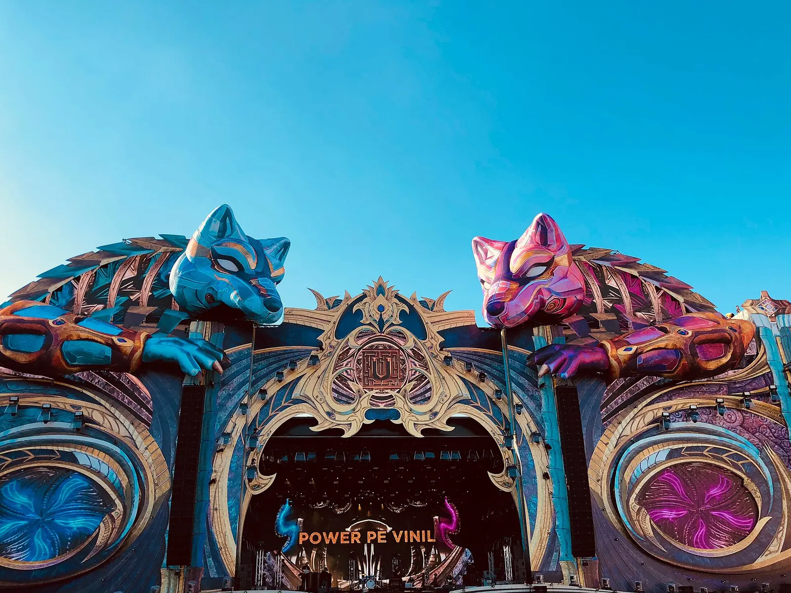 The ornate blue stage structure with fox heads at the Untold festival