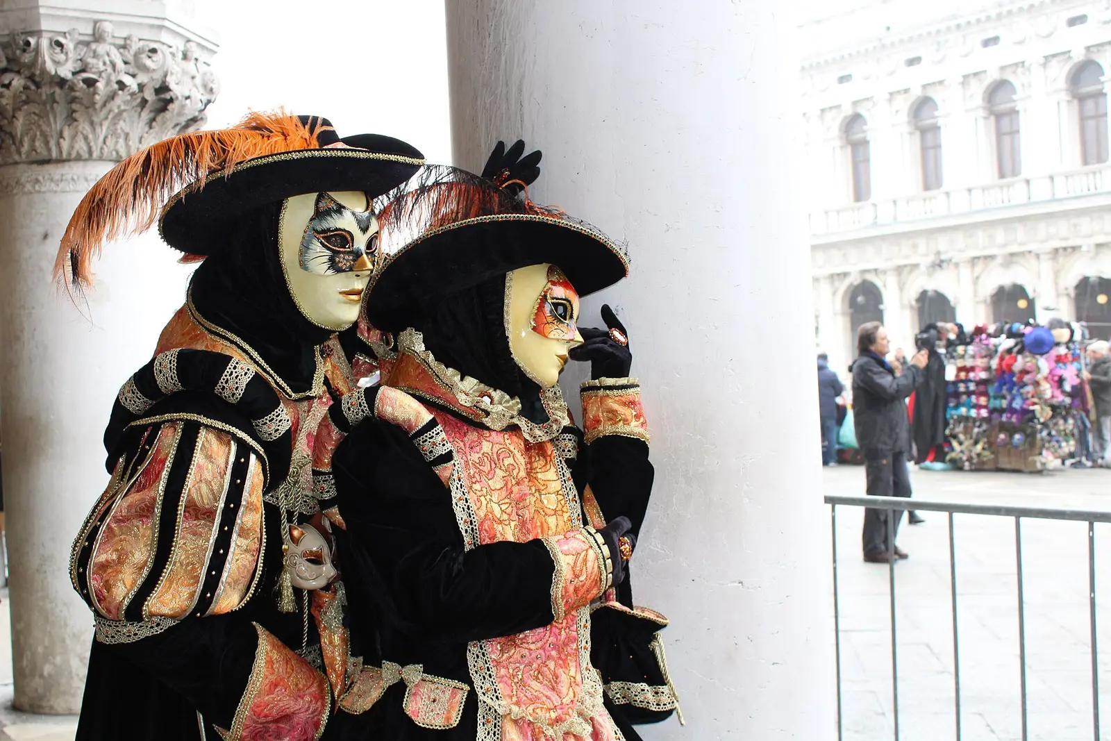 Two people in ornate costumes and masks at the Venice Carnival