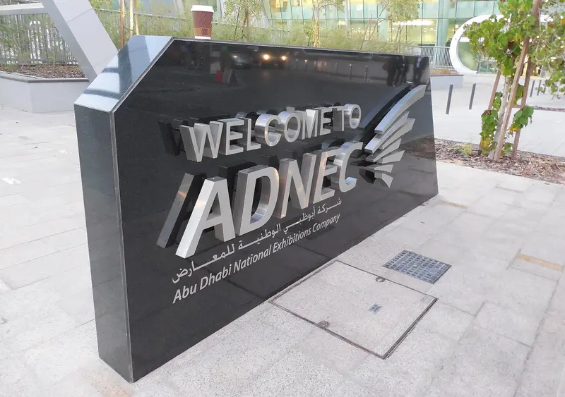 The black stone welcome sign at the entrance to the ADNEC exhibition centre in Abu Dhabi
