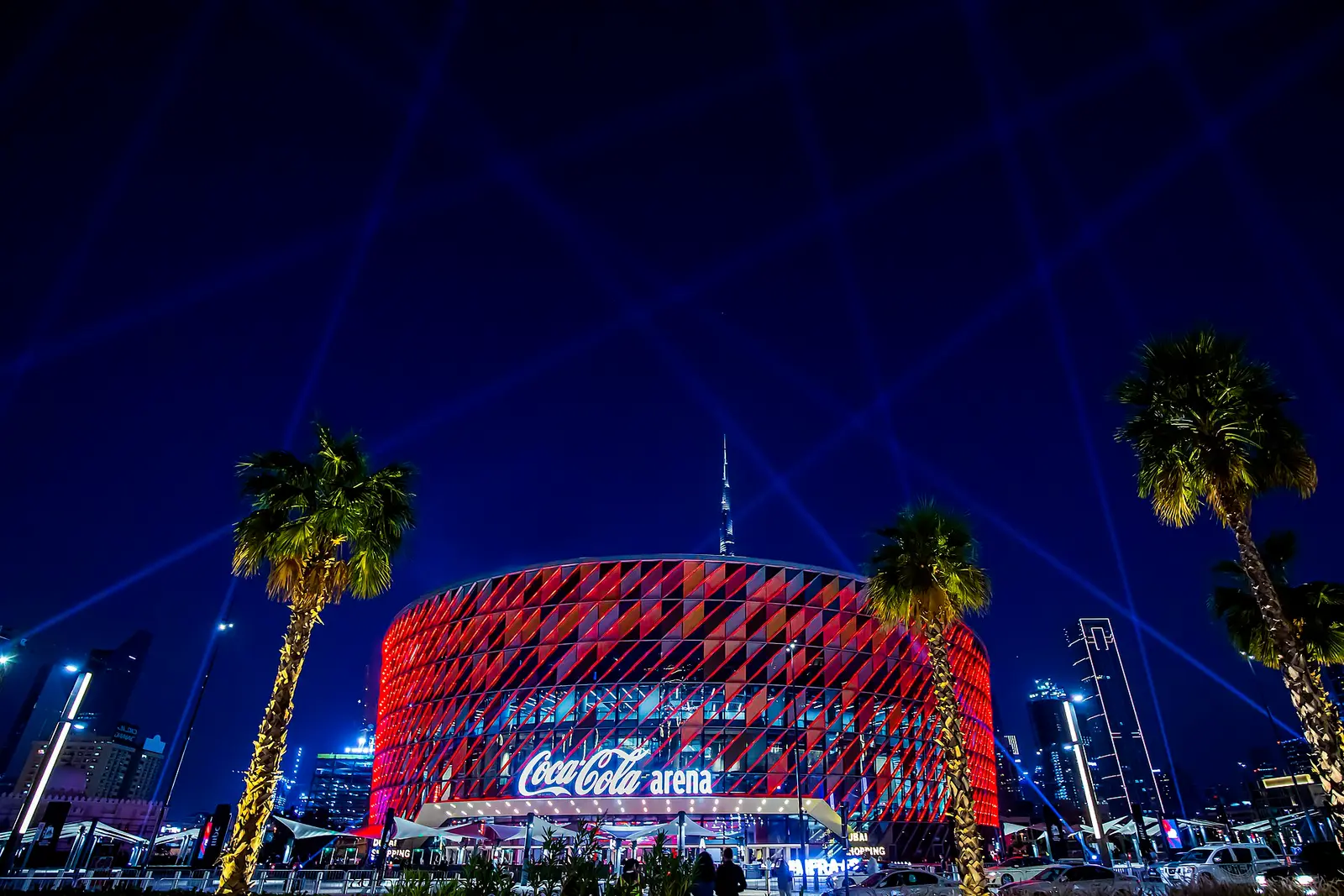 Coca-Cola Arena in Dubai lit in red with laser beams at night