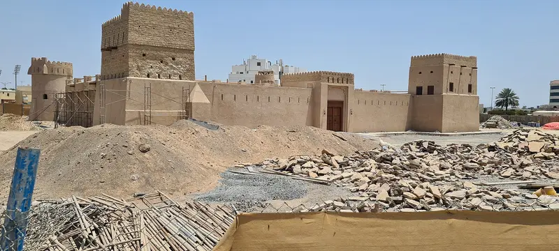 The sand-coloured walls and towers of Dhaid Fort in Al Dhaid, Sharjah, under restoration