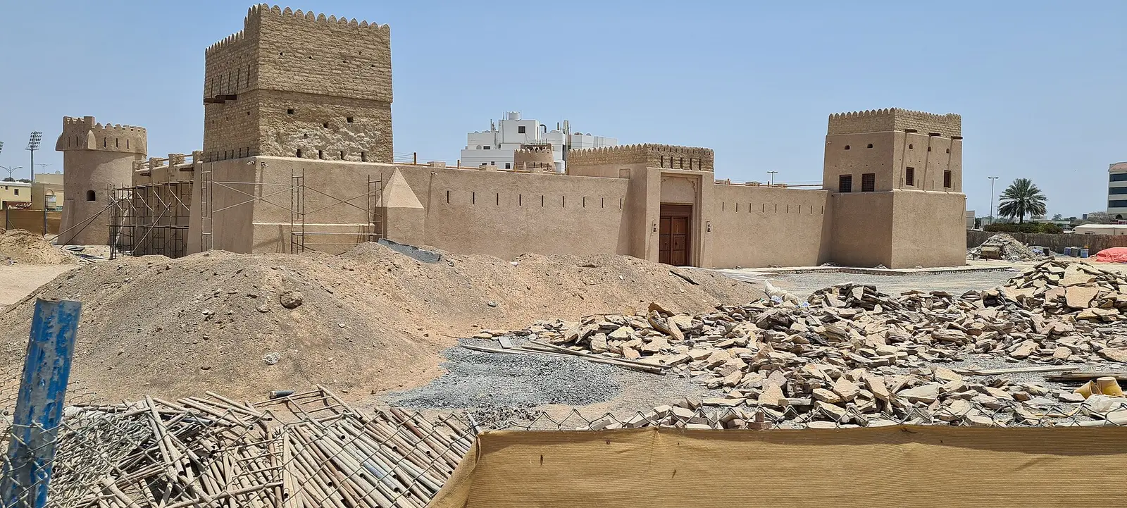 The sand-coloured walls and towers of Dhaid Fort in Al Dhaid, Sharjah, under restoration