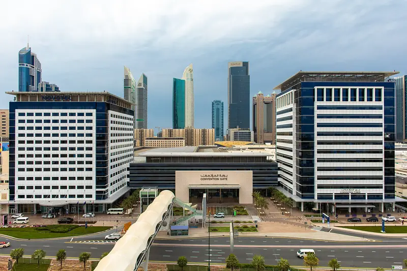 The Dubai World Trade Centre convention gate with towers of Sheikh Zayed Road behind