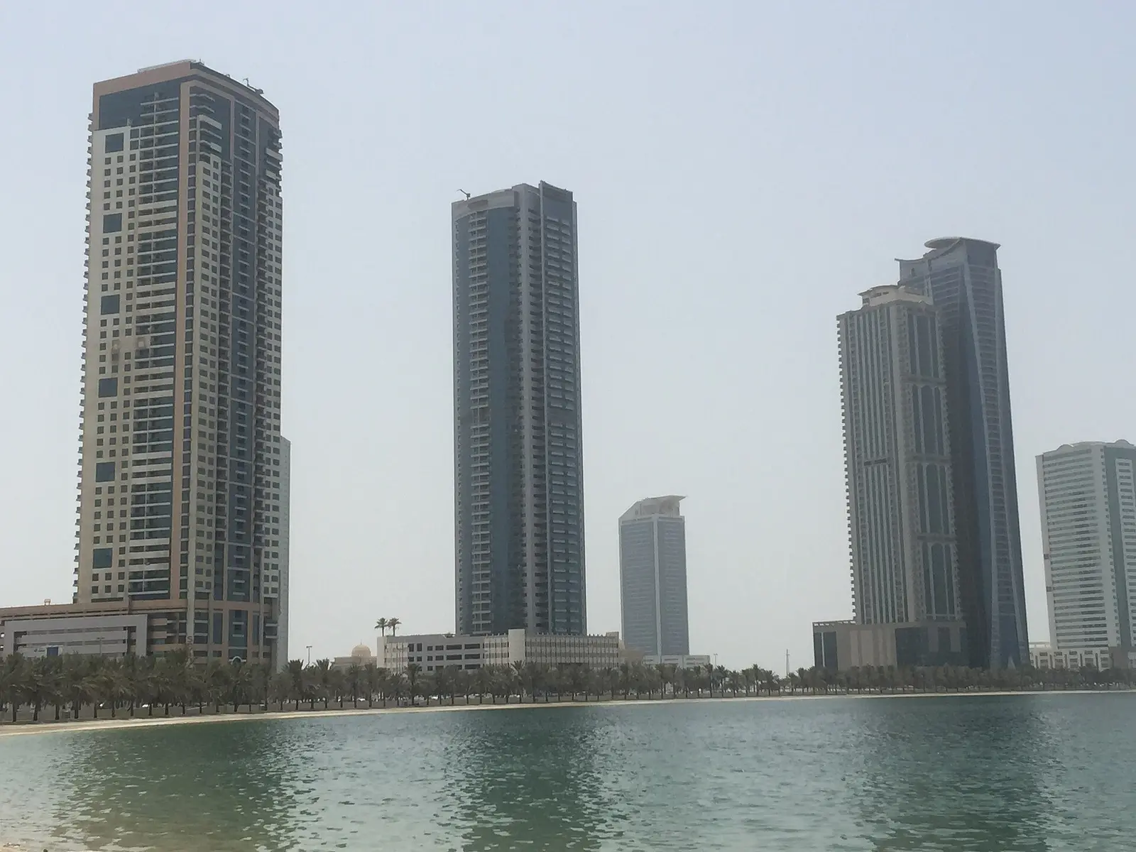 High-rise towers across the water of the lagoon beside Expo Centre Sharjah