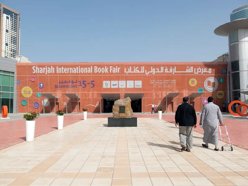 Visitors walking towards the entrance of the Sharjah International Book Fair at Expo Centre Sharjah in 2014